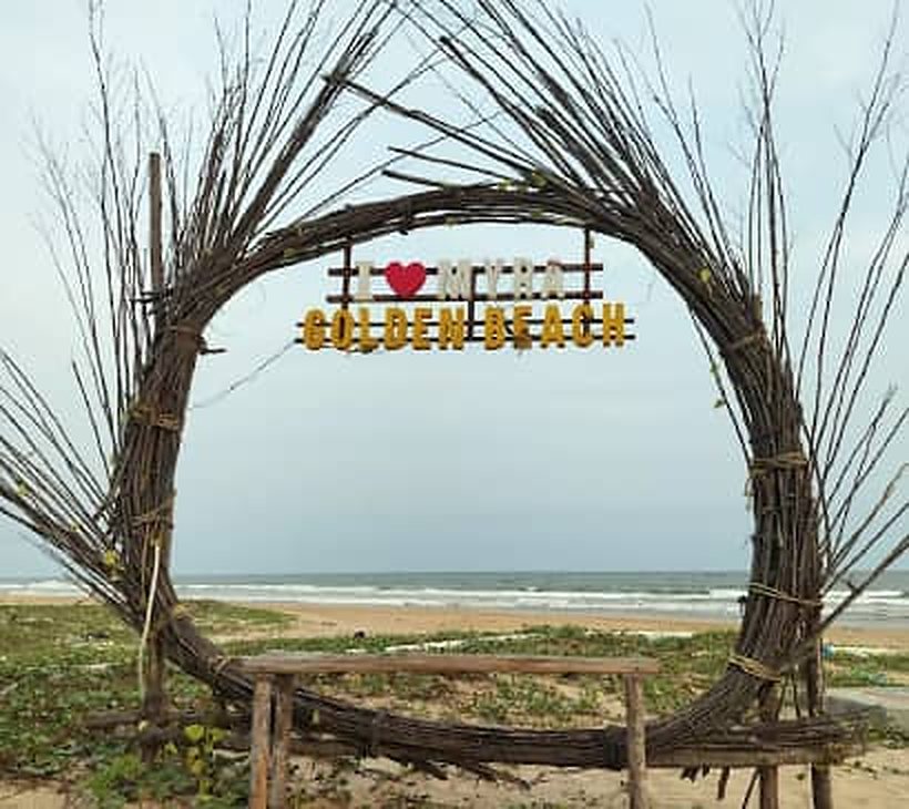 Driftwood arch frame on the beach looking out to the sea